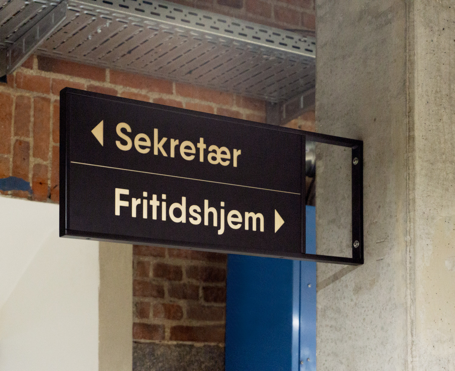 Overhang sign on concrete column.