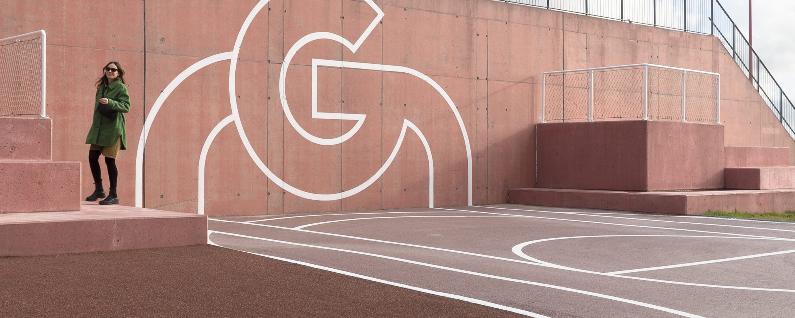 Gigantium graphics on pavement and wall.