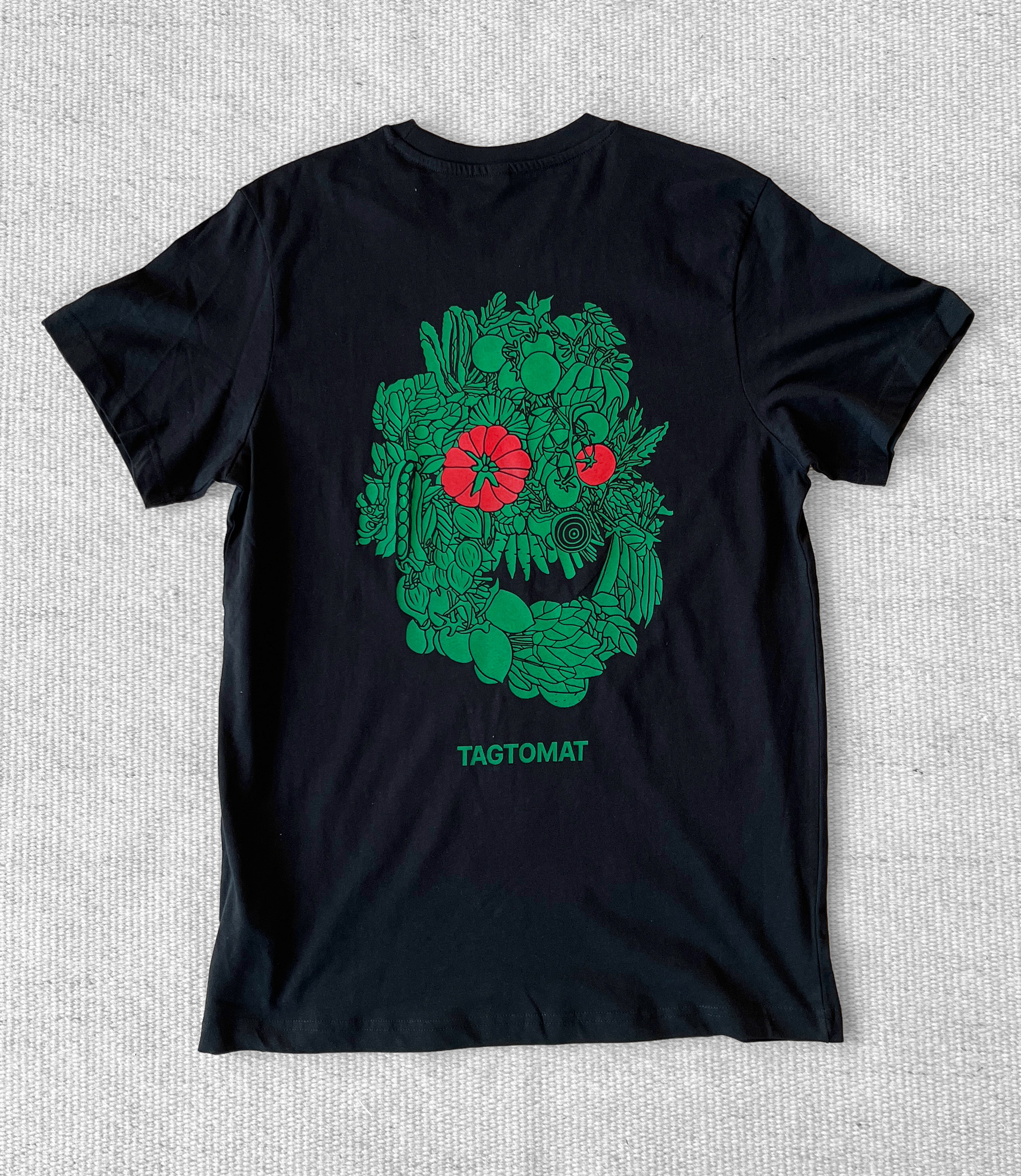 Black TAGTOMAT t-shirt with green head made of plants.