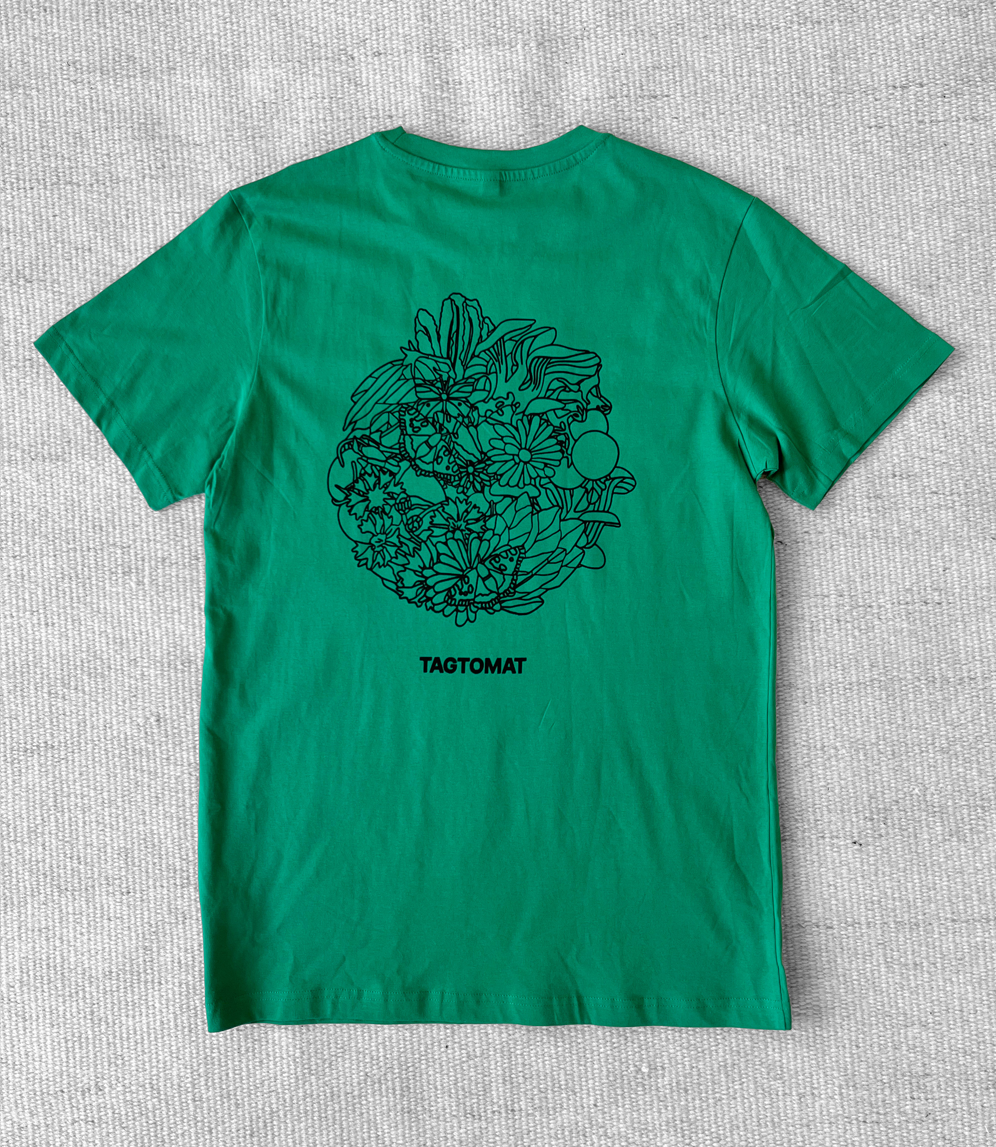 Green TAGTOMAT t-shirt with plant illustrations.